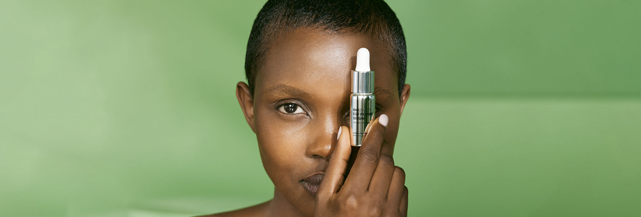 woman holding bioeffect power serum over her eye
