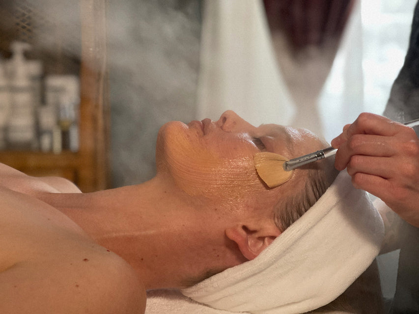 woman receiving facial mud masque treatment at leigh kelley skin studio