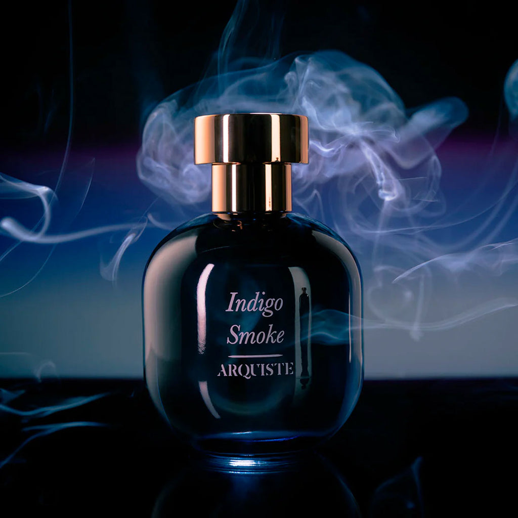 arquiste indigo smoke perfume bottle with smoke behind it