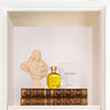 arquiste l'or de louis perfume on top of books with box and sculptre