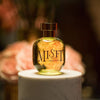 arquiste misfit perfume bottle on marble stand