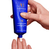 person applying augustinus bader the foaming cleanser to their hands