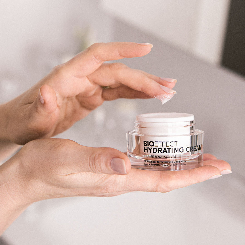 hand dipping into bioeffect Hydrating Cream