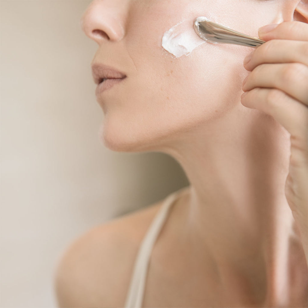 woman applying bioeffect EGF Power Cream with spoon