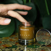 finger dipping into container of Monastery Attar