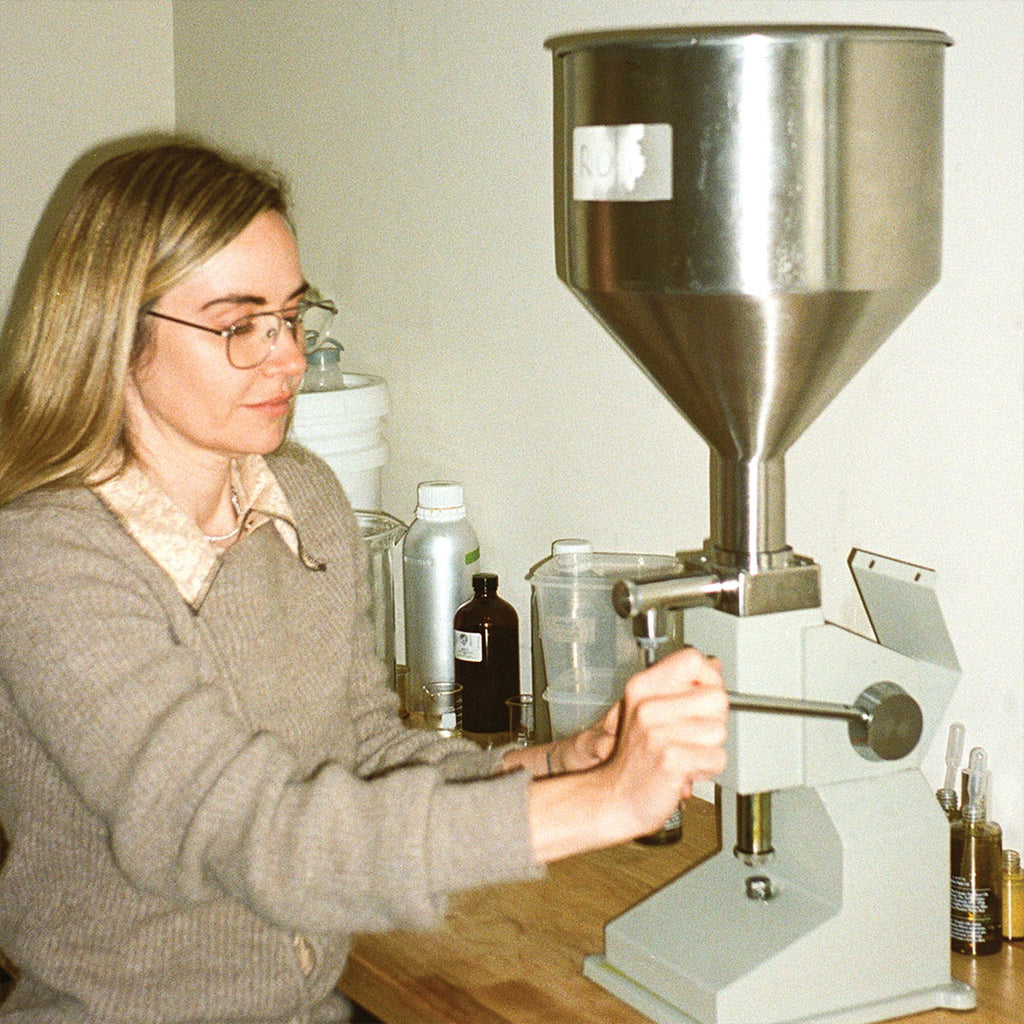 woman pouring skincare into bottle